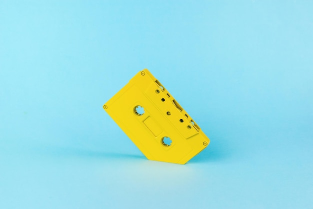 A yellow tape recorder drowning in a blue background