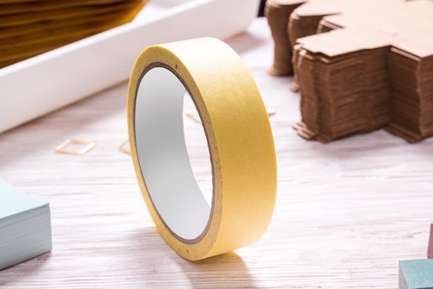 Photo yellow  tape roll  on wooden office table