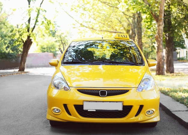 Yellow taxi car on city road