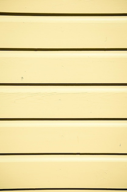黄色の質感のある木製の下見板張りの背景