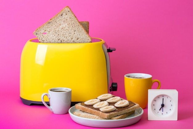 Yellow toaster on a pink background