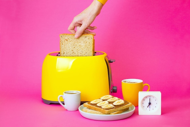 Yellow toaster on a pink background