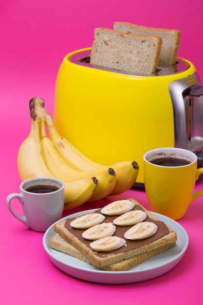 Yellow toaster on a pink background