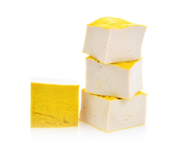 Yellow tofu on white surface