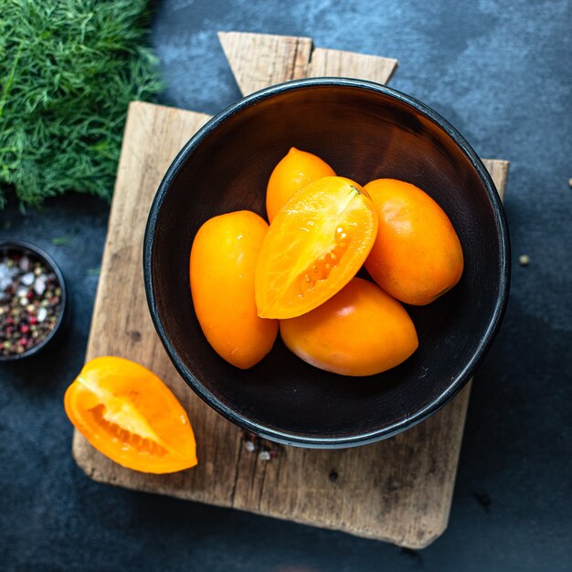 Yellow tomatoes on a bowl