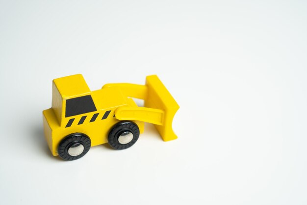 Yellow toy bulldozer Demolition services land leveling and other land works Building destruction Take down Illegal construction Industry machinery for rent