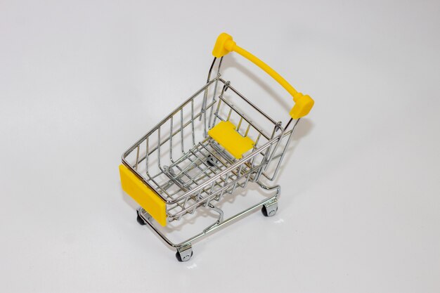 Yellow toy cart on white isolated background