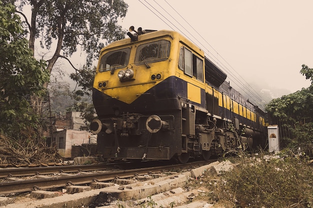 The yellow train goes by rail in the desert. Indian train-the local train. Indian province, village