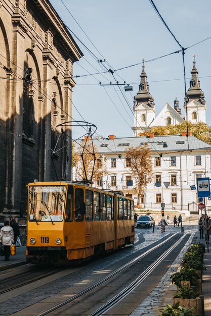 Yellow tram on the old city road in center of Lviv.