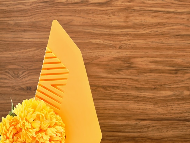Yellow trowel for wallpapering and yellow summer flowers Copy space for text