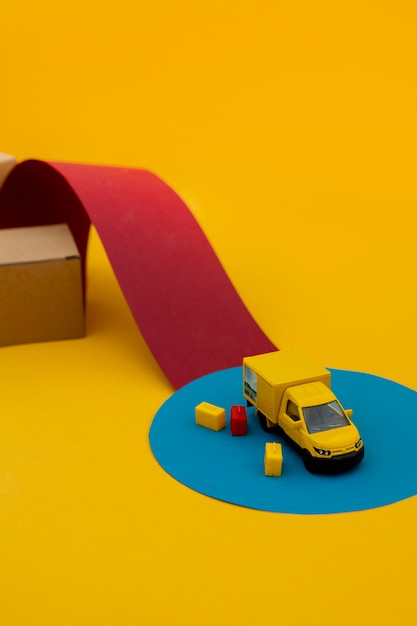 Yellow truck and boxes supply chain concept