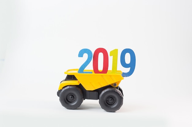 The yellow truck hold 2019 number on white background.