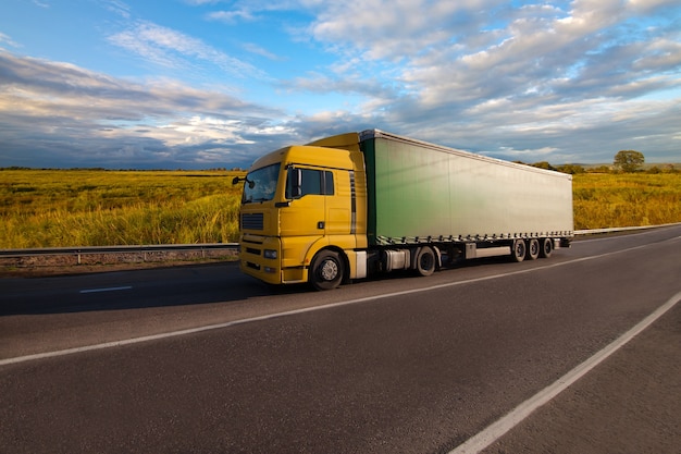 Yellow truck on the road with blurred background