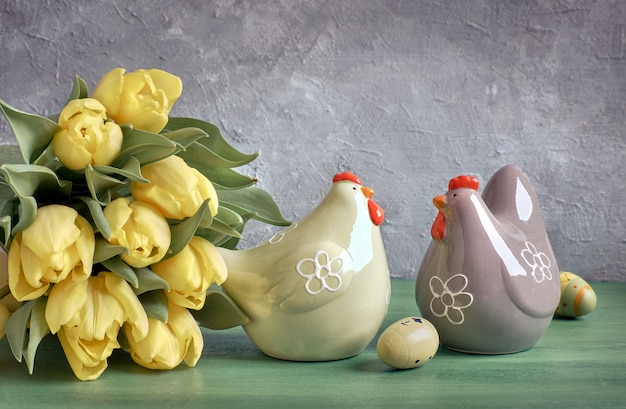 Yellow tulips and ceramic hens