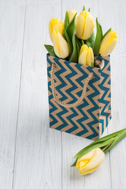 Yellow tulips in kraft package