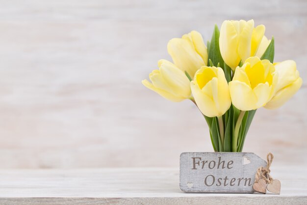 Yellow tulips, spring flowers and Easter decoration.