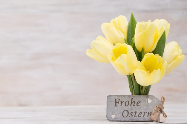 Yellow tulips, spring flowers and Easter decoration.