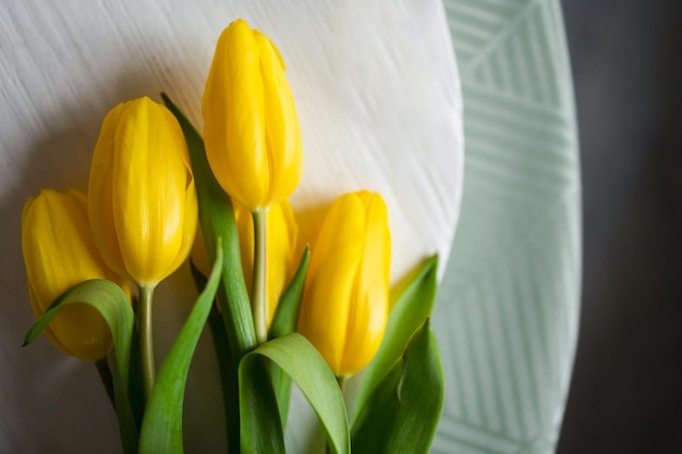 Yellow tulips on the table Fresh spring flowers