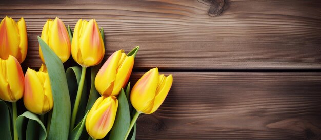 Photo yellow tulips on wooden background as valentines day concept with loved ones