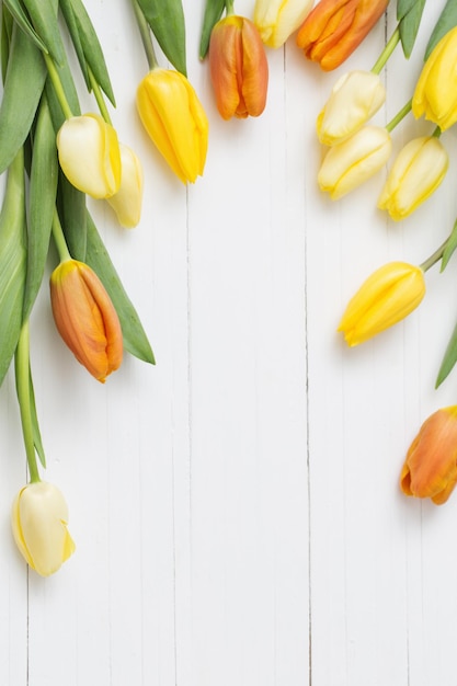 Yellow tulips on wooden background