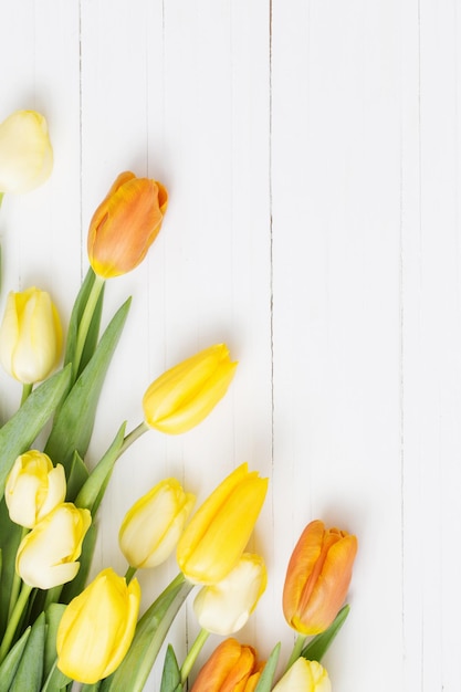 Yellow tulips on wooden background