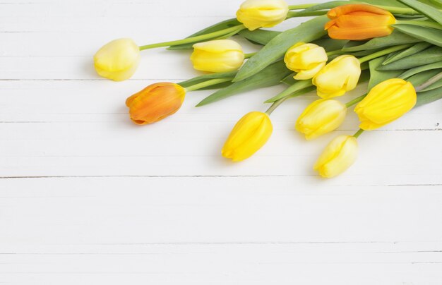 Yellow tulips on wooden background