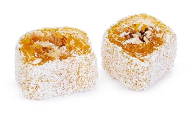 Yellow Turkish Delight with nuts in powdered sugar isolated on white