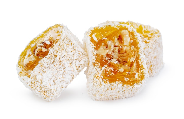 Yellow Turkish Delight with nuts in powdered sugar isolated on white