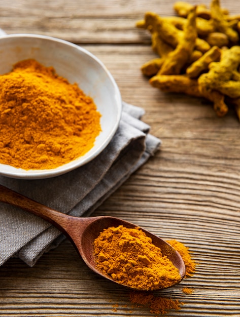 Yellow turmeric powder and dry roots