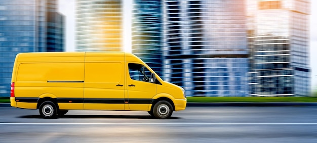 Photo yellow van driving on a city road at sunset in front of a modern cityscape