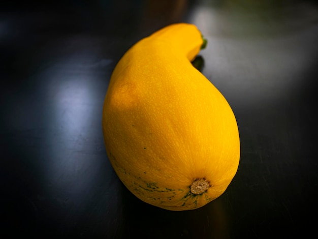 Yellow vegetable zucchini on a black background