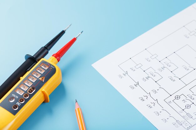 Yellow voltage indicator with an electrical diagram on a blue background. Testing and verification of power grids