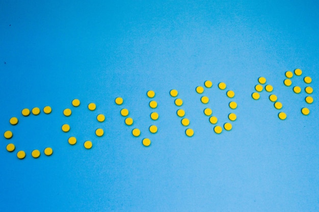 Yellow volumetric tablets are laid out on a blue background in the form of the inscription