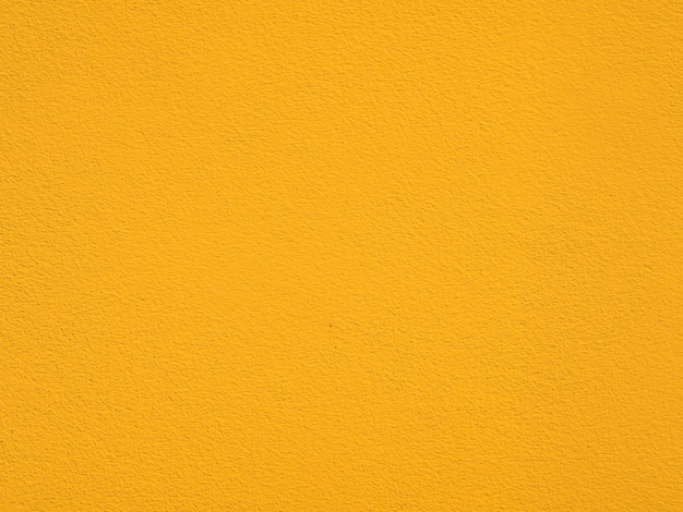 セメントのテクスチャと黄色の壁の背景