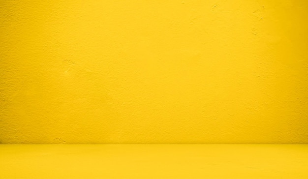 A yellow wall with a black shoe on it and a white wall.