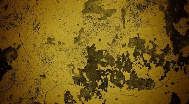 A yellow wall with paint splatters on it