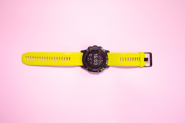 A yellow watch with a yellow band that says'15 : 00'on it