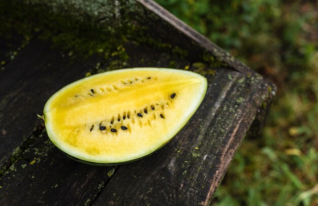 Yellow watermelon on an old wooden surface