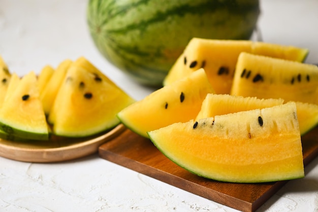 Yellow watermelon slice on wooden background Closeup sweet watermelon slices pieces fresh watermelon tropical summer fruit