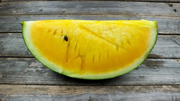 Yellow watermelon slices on wooden plate and isolated on gray background Healthy food Antioxidant