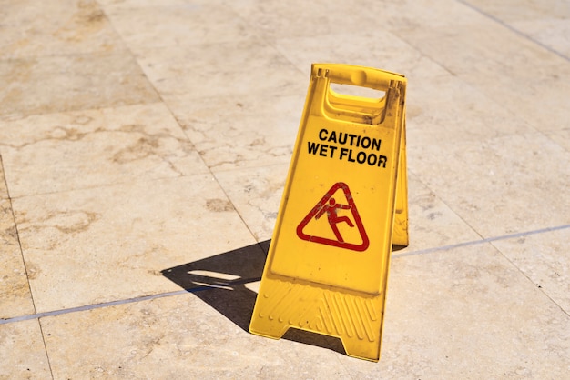 Photo yellow wet floor caution sign