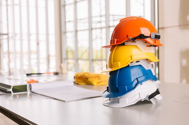 Photo yellow, white, blue, orange helmet safety engineer for project engineering.