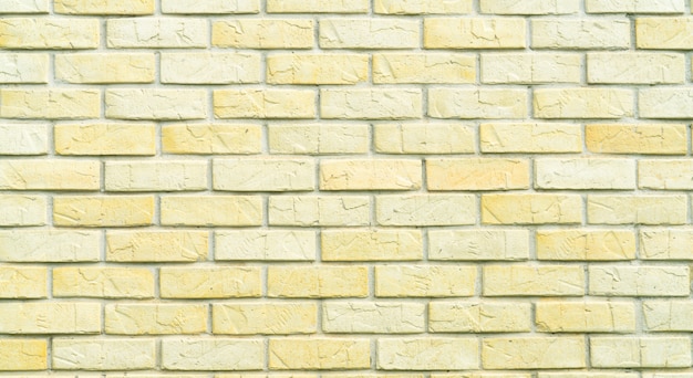 Yellow and white brick wall texture background with space for text. old bricks wallpaper. home interior decoration.