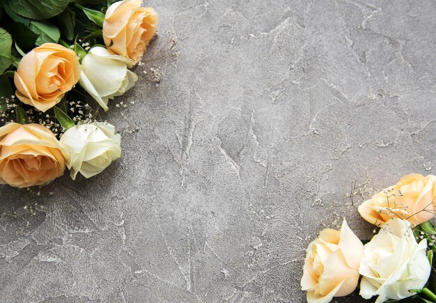 Yellow and white roses on a stone background