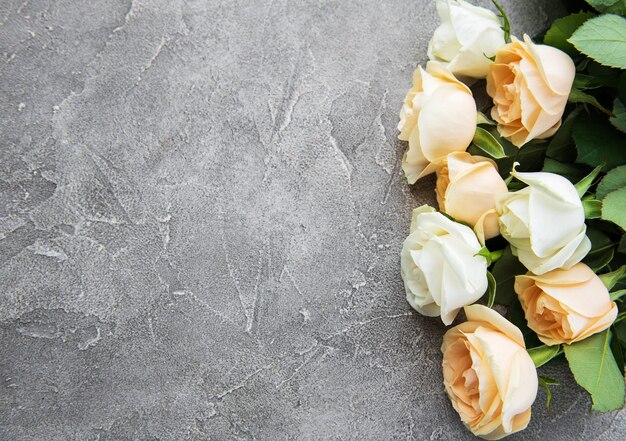 Yellow and white roses on a stone background