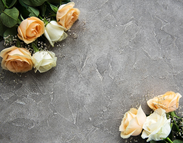 Yellow and white roses on a stone background