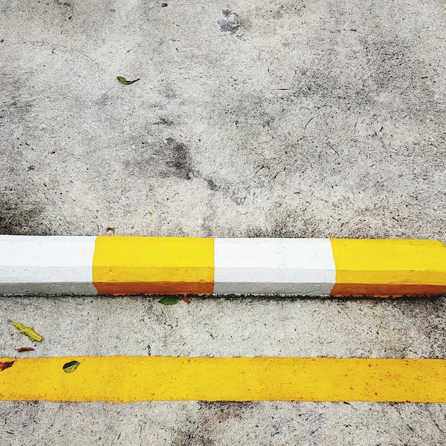 Yellow and white traffic sign on street