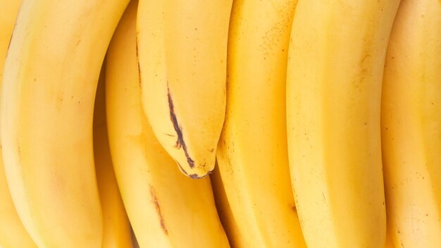 Yellow whole bananas close up background