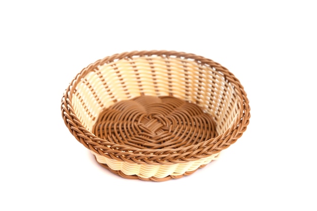 Yellow wicker basket on a white background top view