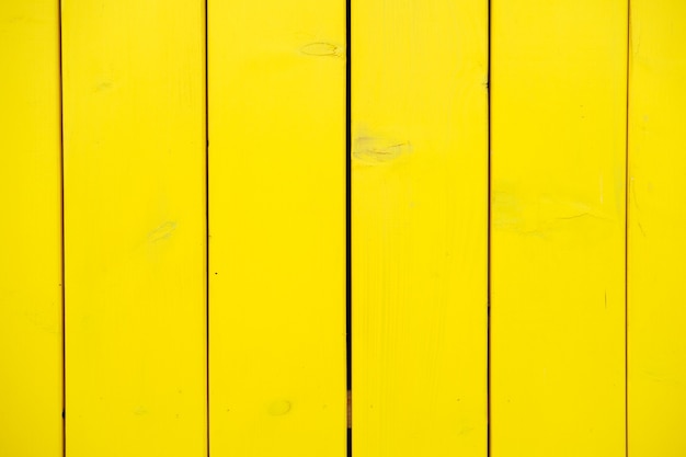 Yellow wood texture. street fence made of wood.close-up